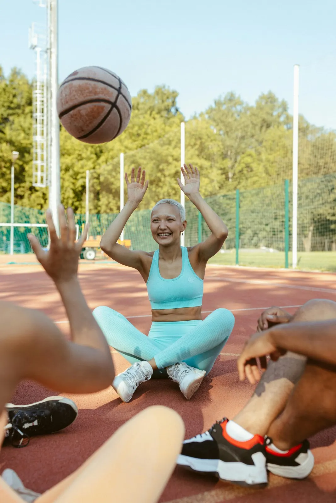 A smiling woman throwing a basketball